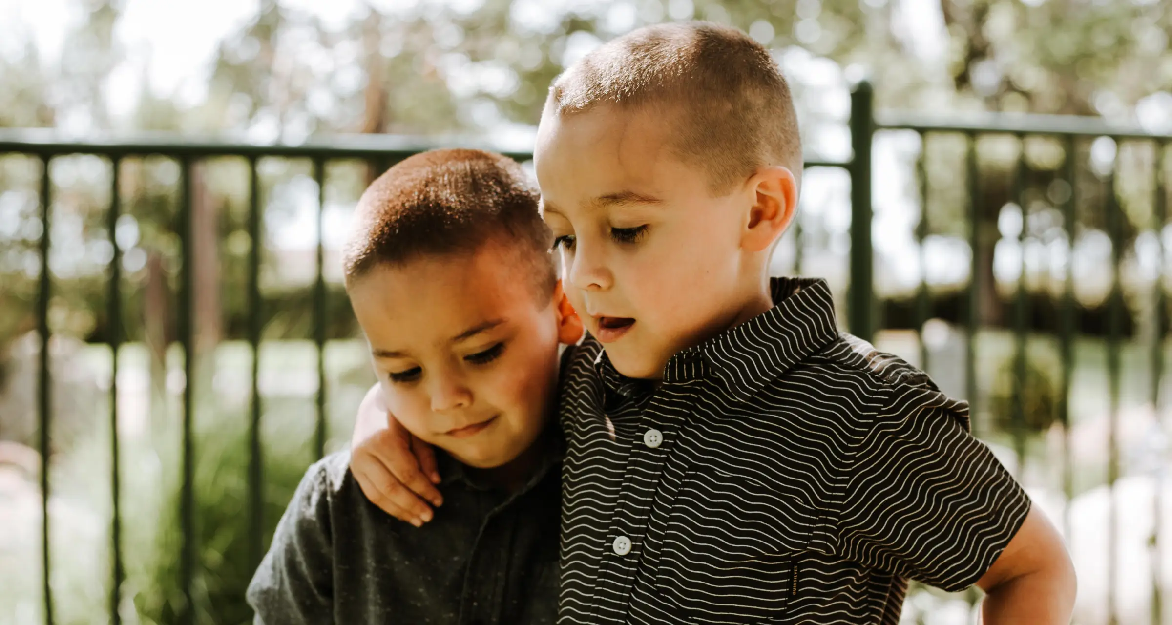 Two little boys holding each other