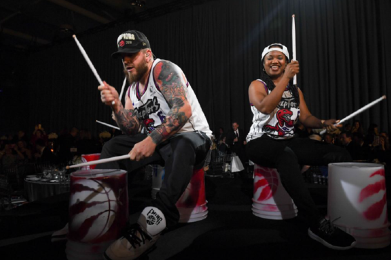 two people playing drums