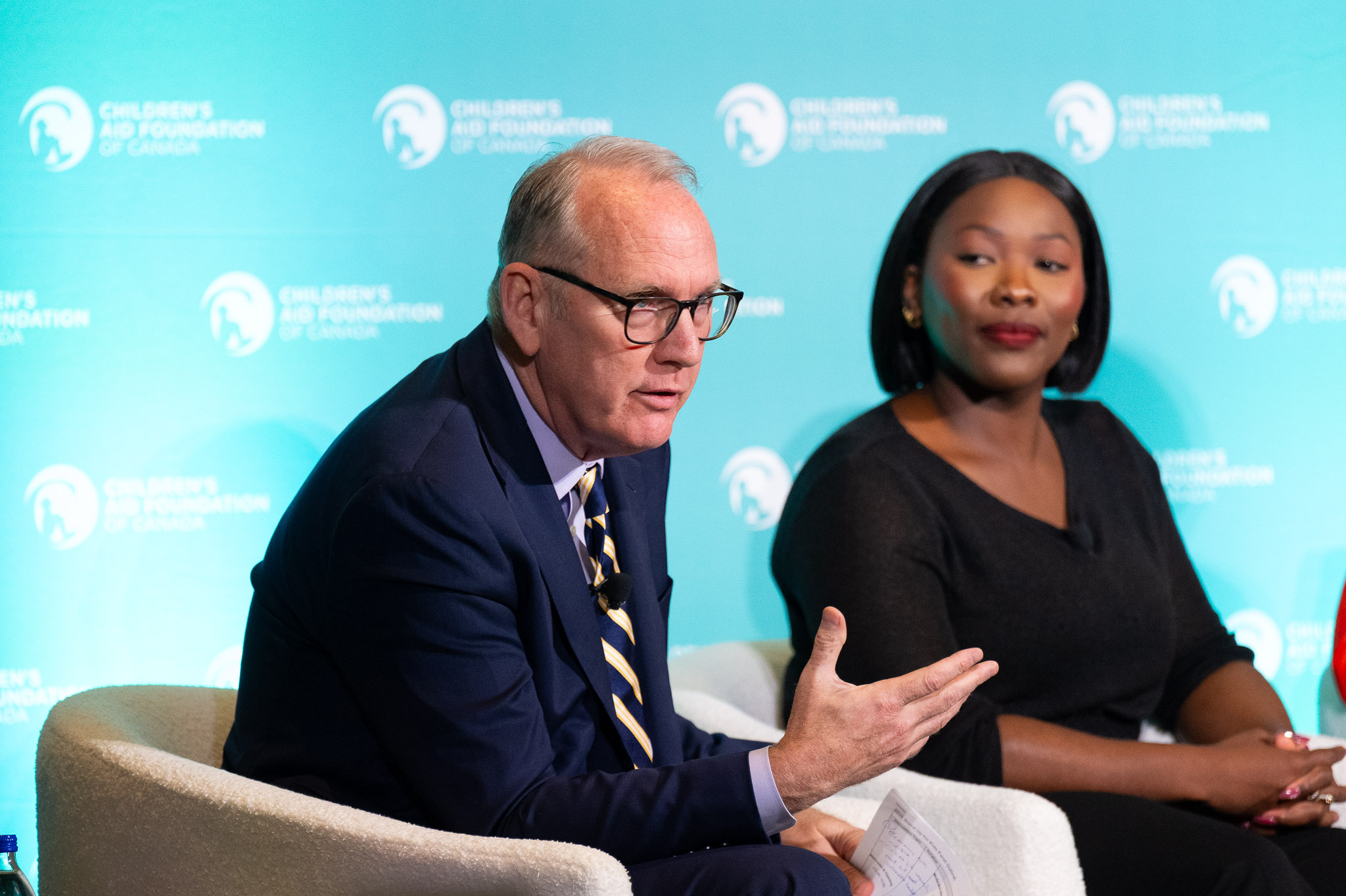 CBC Senior Business Correspondent Peter Armstrong and Erine Roberts speaking on stage